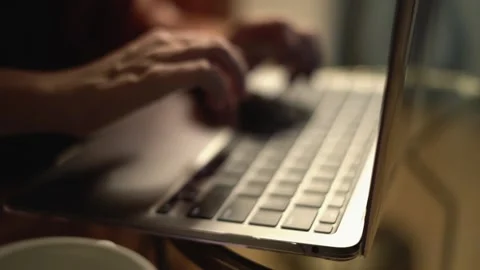 A closeup view showcasing hands actively typing on a contemporary laptop Stock Footage 289965165