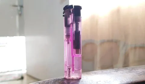 Closeup view of a single plastic purple lighter Stock Photos