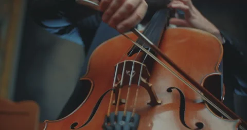 A closeup view of a skilled cellist passionately playing a beautifully 動画素材 303431099