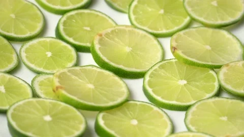 Closeup view slice lemon rotating on the white looking fresh and juicy Stock Footage 195828943