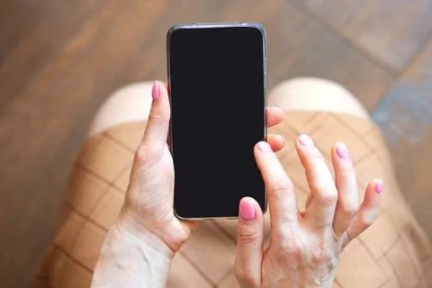 Closeup view of smartphone with black screen in woman hands, copy space concept Stock Photos