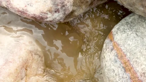 Closeup view of smooth stones and flowing water creating a natural pattern .. Stock-Footage 339369024