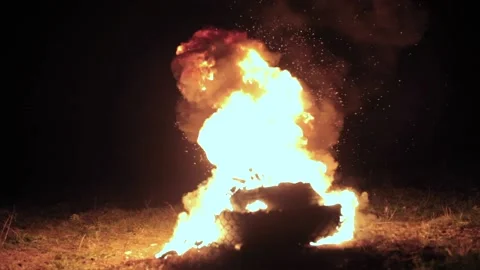 Closeup view of some big tires burning at a festival during a pitch black nig Video stock 132962673