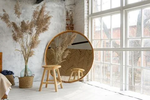 Closeup view on spacious white eco style loft bedroom with  mirror and pampas Stock-Fotos