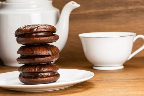 Closeup view stack of choco pie and a cup of hot tea. Closeup view stack o... Foto stock