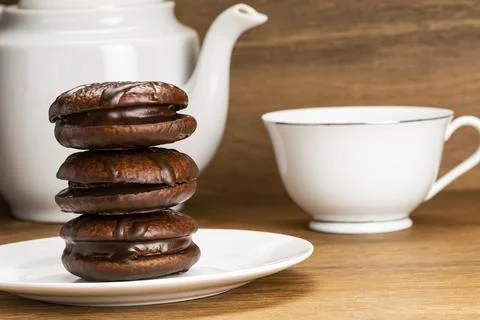 Closeup view stack of delicious homemade choco pie in white ceramic dish and a Stock Photos