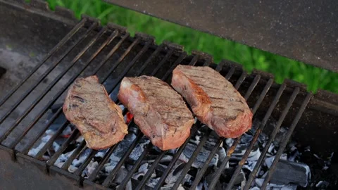 Closeup view of strip steak on grill Stock Footage 250444057