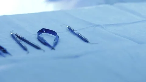 Closeup view of a surgeon's hand which is wearing a white rubber glove pickin Stock Footage 134701738