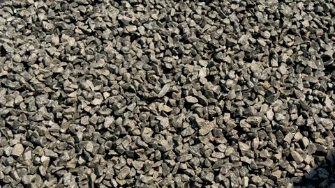 Closeup view of a textured gravel surface with various shades of gray and b.. Stock Footage 339296472