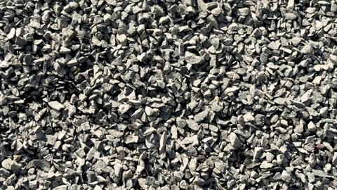 Closeup view of a textured pile of small gray gravel stones in natural sunl.. Stock Footage 339369013