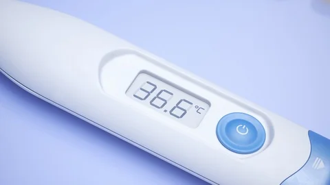 Closeup view at a thermometer with rising temperature value. Fever, flu. 4KHD Stock Footage 119989333