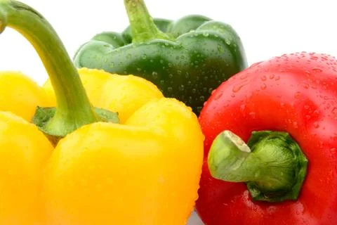 Closeup view of three coloured pepper isolated white background Stock Photos