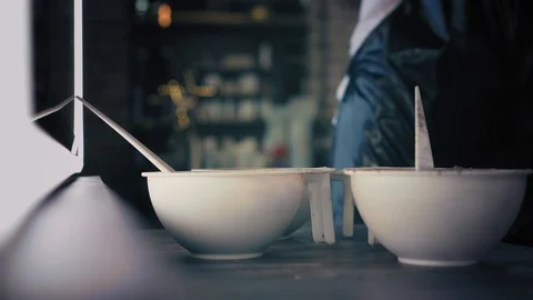 Closeup view on three plastic bowls with different hair dye colours. Hairdresser Stock Footage 86704805