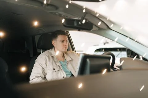 Closeup view through windshield of pensive male customer examining checking auto Stock Photos
