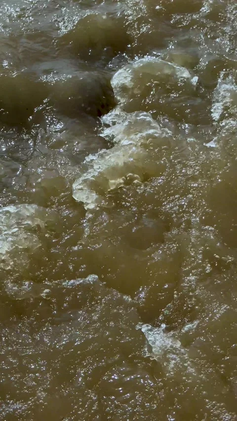 Closeup view of turbulent muddy water with swirling patterns and dynamic mo.. Stock Footage 338414367