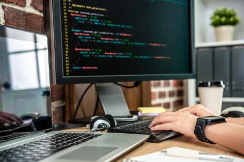 Closeup view of typing codes on computer 스톡 사진