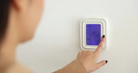 Closeup view unknown female hand press button reduce temperature inside Stock Footage 273125249
