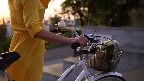 Closeup view of an unrecognizable woman's hands holding a bicycle handlebar with Видео 79639382
