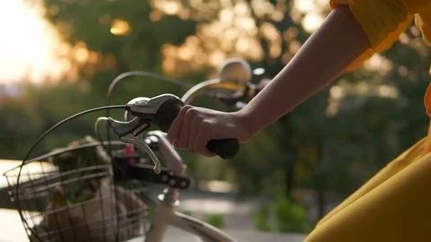 Closeup view of an unrecognizable woman's hands holding a handlebar while riding Stock-Footage 79639491