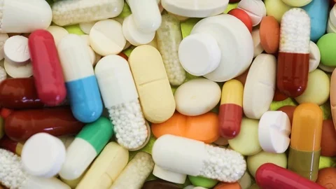 Closeup view of varied selection of pills spinning Stock Footage 97822643