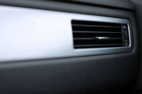 Closeup view on the ventilation grille in the dashboard of a modern car Stock Photos