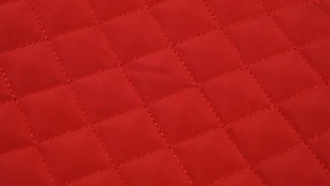 Closeup view video of bright red quilted texture of fabric. Stock Footage 129150677