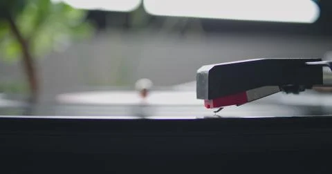 Closeup view of vintage headshell of portable record player strart playing on Stock Photos