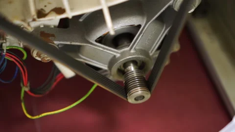 Closeup view of washing laundry machine electric motor shaft spindle and belt Video stock 130473770