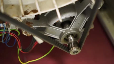 Closeup view of washing laundry machine electric motor shaft spindle and belt Video stock 153932071
