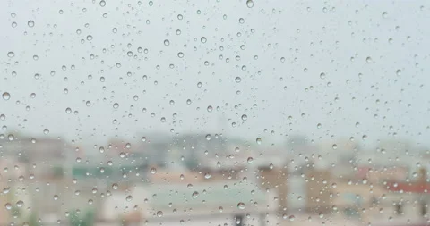 Closeup view of water drops falling on glass. Rain running down on window. Rainy Stock-Footage 131659192