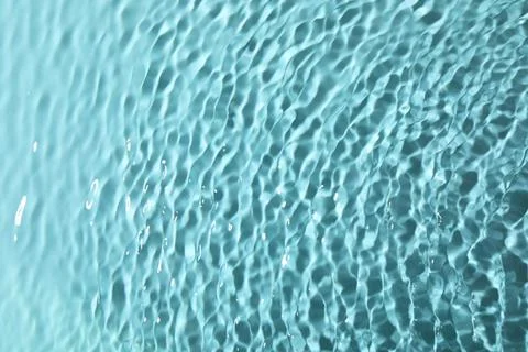 Closeup view of water with rippled surface on light blue background Stock Photos