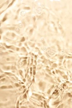 Closeup view of water with rippled surface on beige background Foto stock