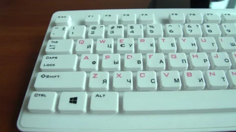 Closeup view of white computer keyboard highlighting alphabet Stock Footage 165690498