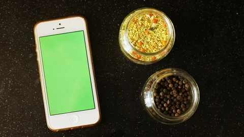 Closeup view of white smartphone mobile with empty green screen and spices herbs 스톡 동영상 89772929