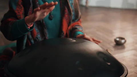 Closeup view of woman's hands playing on hangpan at home. Stock Footage 180657891