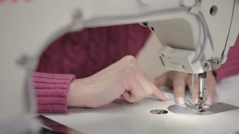 Closeup view of a woman's hands sewing a fabric of cloth. Stock Footage 132965953