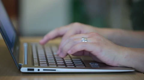 A closeup view on woman's hands when she types on a laptop at home Stock Footage 42980087