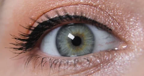 Closeup view of woman's opening beautiful eye with green iris and make-up. Stock Footage 147435191