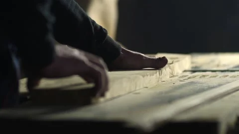 Closeup view of a woodcutter's hands while they are pushing lumber up a new w Stock Footage 134701910