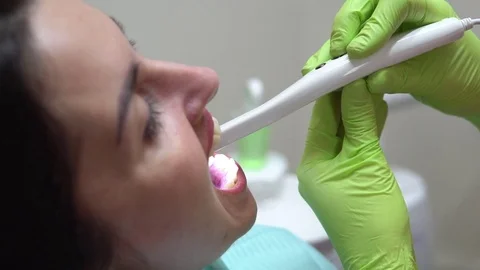 Closeup view of young female dentist examining the mouth of a patient with an Stock Footage 74441553