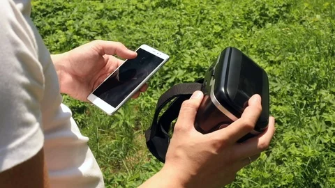 Closeup view of young man hands holding VR glasses and using smartphone mobile 스톡 동영상 91901606