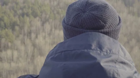 Closeup view young man hiker tourist looking with binocular on the top of rock Video stock 84878309