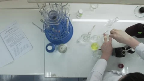 Closeup view of a young scientist preparing an unique chemical, liquid. Stock Footage 132972308