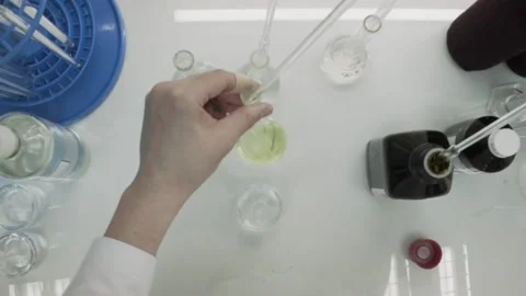Closeup view of a young scientist preparing a medical liquid. Stock Footage 132972363
