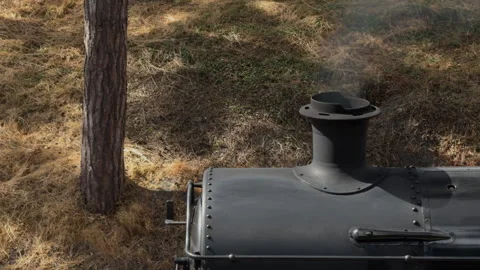 Closeup of a vintage coal train engine emitting smoke in darkness Stock Footage 328020859