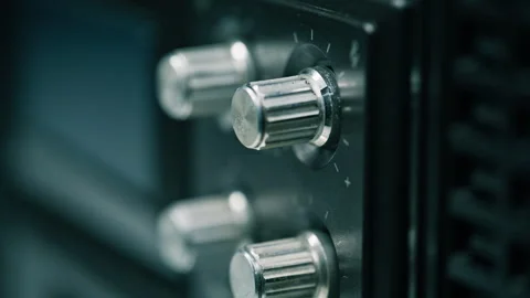 Closeup vintage radio knobs. Dial reflecting light. Traditional music equipment Stock Footage 332362702