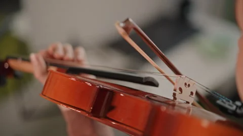 Closeup of violin bowing technique. Slow practice showing bow and hand Stock Footage 346555716