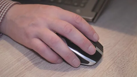 A CloseUp Visual of a Hand Actively Using a Computer Mouse on a Desk Surface Stock Footage 305911381