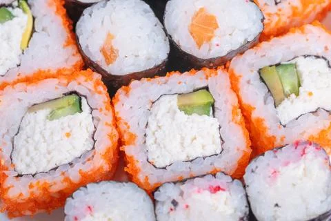 Closeup of vivid sushi with avocado cheese and sesame toppings. Detailed shot of Stock Photos