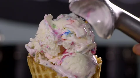 Closeup Of Waffle Cone, Woman Adds Another Scoop Of Colorful Ice Cream On Top Stock Footage